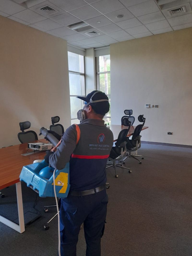 Wipeout technician fogging a commercial office meeting room in the UAE
